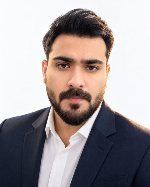 Portrait of Wajahat Mubashir, WordPress developer and marketing technology engineer, in a navy blazer and white shirt against a light background